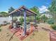 Outdoor entertaining area featuring a covered pergola with a built-in barbecue grill and seating at 6902 Coral Cove Dr, Orlando, FL 32818