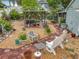 Landscaped backyard with brick paver walkways, seating, barbecue and decorative potted plants at 6902 Coral Cove Dr, Orlando, FL 32818