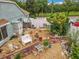 Backyard featuring gravel, patio area, bench, shed, privacy fence, and mature landscaping at 6902 Coral Cove Dr, Orlando, FL 32818