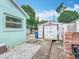 Exterior shot of the backyard featuring storage shed, brick pavers, and rock groundcover at 6902 Coral Cove Dr, Orlando, FL 32818