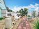Serene backyard featuring decorative gravel, brick pavers, lush landscaping, and comfortable seating at 6902 Coral Cove Dr, Orlando, FL 32818