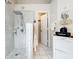 Large walk-in shower features tile surround, handheld sprayer and shower head in updated bathroom at 6902 Coral Cove Dr, Orlando, FL 32818