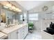 Bright bathroom with double vanity, tile floor, garden window, and beach-themed decor at 6902 Coral Cove Dr, Orlando, FL 32818