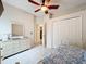 Cozy bedroom featuring tile floors, ceiling fan, and large closet for ample storage at 6902 Coral Cove Dr, Orlando, FL 32818
