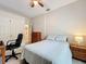 Bright bedroom featuring a ceiling fan, tiled floors, a large bed, and plenty of storage at 6902 Coral Cove Dr, Orlando, FL 32818