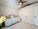 Bright bedroom featuring tiled floors, a ceiling fan, and ample closet space at 6902 Coral Cove Dr, Orlando, FL 32818