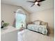 Sunlit bedroom with vaulted ceilings, neutral walls, tile flooring, and a comfortable daybed at 6902 Coral Cove Dr, Orlando, FL 32818