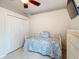 This bedroom includes a ceiling fan, closet, dresser, window, and tile flooring at 6902 Coral Cove Dr, Orlando, FL 32818