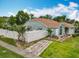 Charming single-story home featuring a well-manicured lawn and a white picket fence at 6902 Coral Cove Dr, Orlando, FL 32818