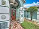 Close-up of the front porch with charming decor and architectural details at 6902 Coral Cove Dr, Orlando, FL 32818