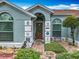 Inviting front entrance showcasing detailed stonework, a decorative door, and lush landscaping at 6902 Coral Cove Dr, Orlando, FL 32818