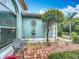 The front yard features a decorative tree with mounted water feature and sitting bench at 6902 Coral Cove Dr, Orlando, FL 32818