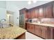 Inviting kitchen featuring granite countertops, stainless steel appliances and brown cabinets at 6902 Coral Cove Dr, Orlando, FL 32818