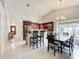 Bright kitchen featuring granite countertops, dark wood cabinetry, and stainless steel appliances at 6902 Coral Cove Dr, Orlando, FL 32818