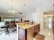Open kitchen featuring an island with granite countertops, stainless steel appliances and tile floors at 6902 Coral Cove Dr, Orlando, FL 32818