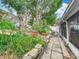 Lush garden pathway featuring tropical plants, stone accents, and a well-maintained walkway at 6902 Coral Cove Dr, Orlando, FL 32818