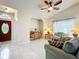 Spacious living room showcasing neutral walls, tiled floors, comfortable seating, and natural light at 6902 Coral Cove Dr, Orlando, FL 32818