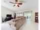 Open living room with vaulted ceiling, ceiling fan and sliding glass doors leading to a lanai at 6902 Coral Cove Dr, Orlando, FL 32818