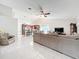 Bright, open living room featuring tile floors and an adjacent view of the kitchen at 6902 Coral Cove Dr, Orlando, FL 32818