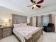 Spacious main bedroom featuring a ceiling fan, tile floors, and large windows for natural light at 6902 Coral Cove Dr, Orlando, FL 32818