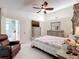 Main bedroom featuring tile floors, neutral walls, and a doorway leading to the bathroom at 6902 Coral Cove Dr, Orlando, FL 32818