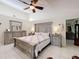 Comfortable main bedroom featuring a ceiling fan, ample closet space, and an ensuite bathroom at 6902 Coral Cove Dr, Orlando, FL 32818