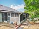 Enclosed screened porch addition with solar panels on the roof of this charming residential home at 6902 Coral Cove Dr, Orlando, FL 32818