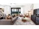 Cozy living room with a comfortable sofa, stylish decor, and sliding glass doors leading to the backyard at 769 Tundra Loop, Groveland, FL 34736