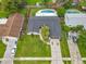 Aerial view of a single-Gathering home featuring a swimming pool and well-maintained lawns at 8676 Hillside Dr, Orlando, FL 32810