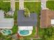 Aerial view of home showing roof, driveway, and backyard pool at 8676 Hillside Dr, Orlando, FL 32810