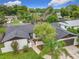 Aerial view of a single-Gathering home featuring an attached garage and beautiful landscaping at 8676 Hillside Dr, Orlando, FL 32810