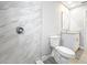 The bathroom features a shower with marbled walls, a toilet, and a vanity sink at 8676 Hillside Dr, Orlando, FL 32810