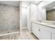 Bathroom features a glass-enclosed shower, dual sinks and modern fixtures at 8676 Hillside Dr, Orlando, FL 32810