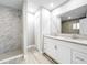 Bathroom features a glass-enclosed shower, dual sinks and modern fixtures at 8676 Hillside Dr, Orlando, FL 32810
