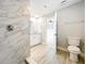 Bathroom features a glass-enclosed shower, toilet and modern fixtures at 8676 Hillside Dr, Orlando, FL 32810