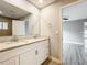 Bathroom with double sink vanity and view into bedroom at 8676 Hillside Dr, Orlando, FL 32810