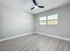 Bright bedroom showcasing gray walls, wood-look floors, a window, and a ceiling fan at 8676 Hillside Dr, Orlando, FL 32810