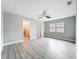 Bright bedroom features wood-look floors, ceiling fan, and a walk-in closet at 8676 Hillside Dr, Orlando, FL 32810