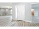 Bright entryway showcasing light gray walls, hardwood floors, and modern door at 8676 Hillside Dr, Orlando, FL 32810
