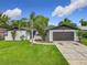 Charming single-Gathering home featuring a well-maintained lawn, brick accents and attached two car garage at 8676 Hillside Dr, Orlando, FL 32810