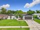 Charming single-Gathering home featuring a well-maintained lawn, brick accents and attached two car garage at 8676 Hillside Dr, Orlando, FL 32810