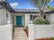 Charming single-Gathering home featuring a colorful front door, lush landscaping and brick accents at 8676 Hillside Dr, Orlando, FL 32810