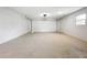 This is a view of a bright garage with a window and newly finished concrete floor at 8676 Hillside Dr, Orlando, FL 32810