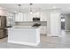 Modern kitchen with white cabinets, center island, and stainless-steel appliances at 8676 Hillside Dr, Orlando, FL 32810