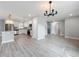 Modern kitchen with island overlooking spacious living area with wood flooring at 8676 Hillside Dr, Orlando, FL 32810