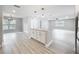 Spacious, open concept living room with island, modern lighting, and wood-look floors at 8676 Hillside Dr, Orlando, FL 32810
