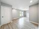 Well-lit living room with wood-look floors and neutral paint at 8676 Hillside Dr, Orlando, FL 32810