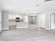 An open living room showcases the kitchen and light hardwood floors at 8676 Hillside Dr, Orlando, FL 32810