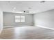 A spacious living room with light hardwood floors, recessed lighting, and a ceiling fan at 8676 Hillside Dr, Orlando, FL 32810