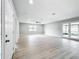 Spacious living room featuring light hardwood floors and access to a screened-in lanai at 8676 Hillside Dr, Orlando, FL 32810